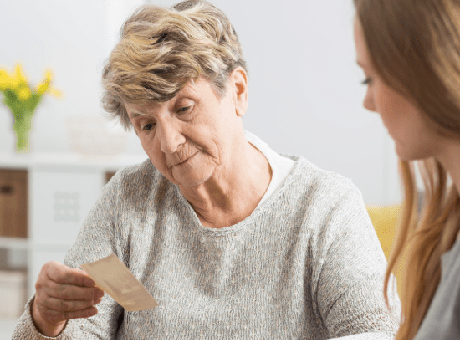 Senior and caregiver looking at photos Steps To Care - AH Westchester, IL IL