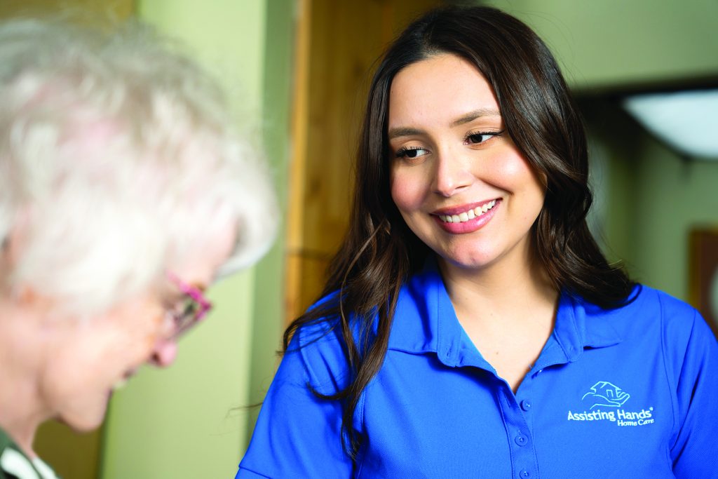 caregiver smiling at elderly woman