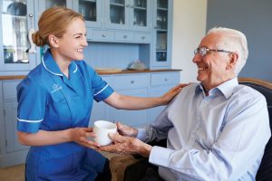 Caregiver and Senior Man smiling