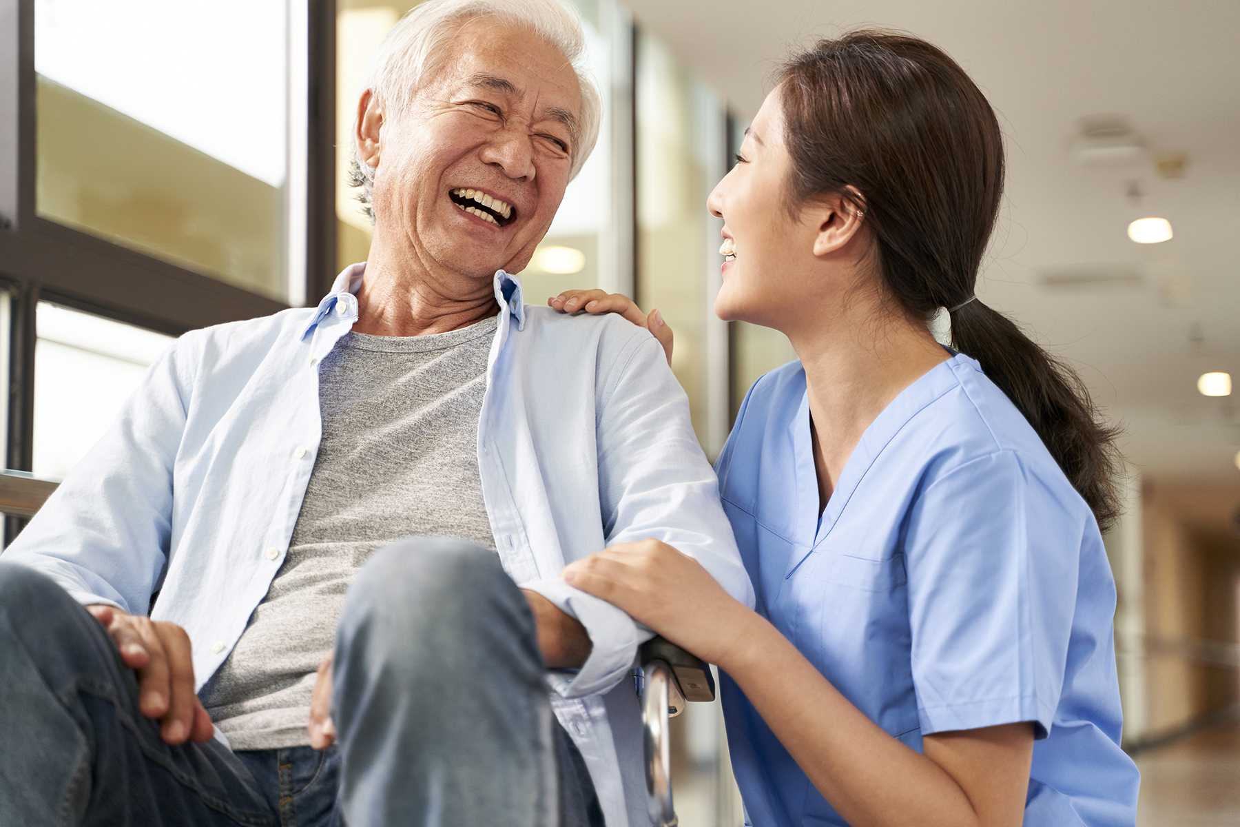 friendly caretaker talking to senior man