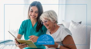 Caregiver helping elderly woman read