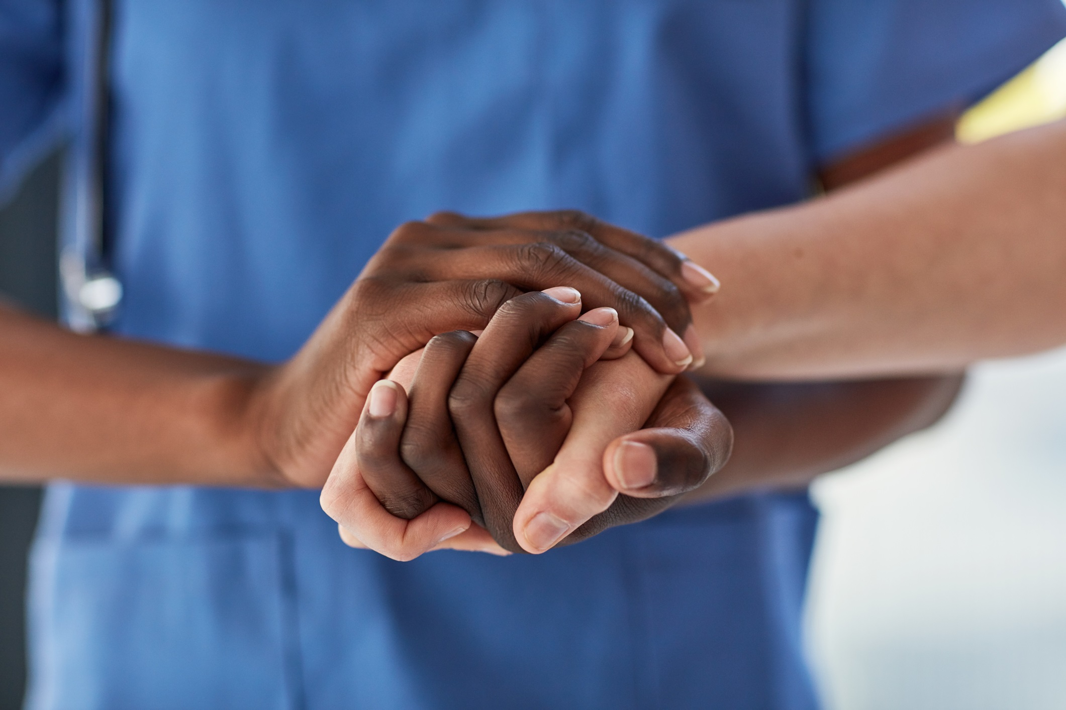 caregiver and senior holding hands companionship